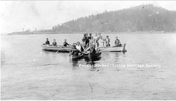 Children in row boats from Kleindale and Irvines Landing arrive at Donley's Landing to attend school, circa 1917.